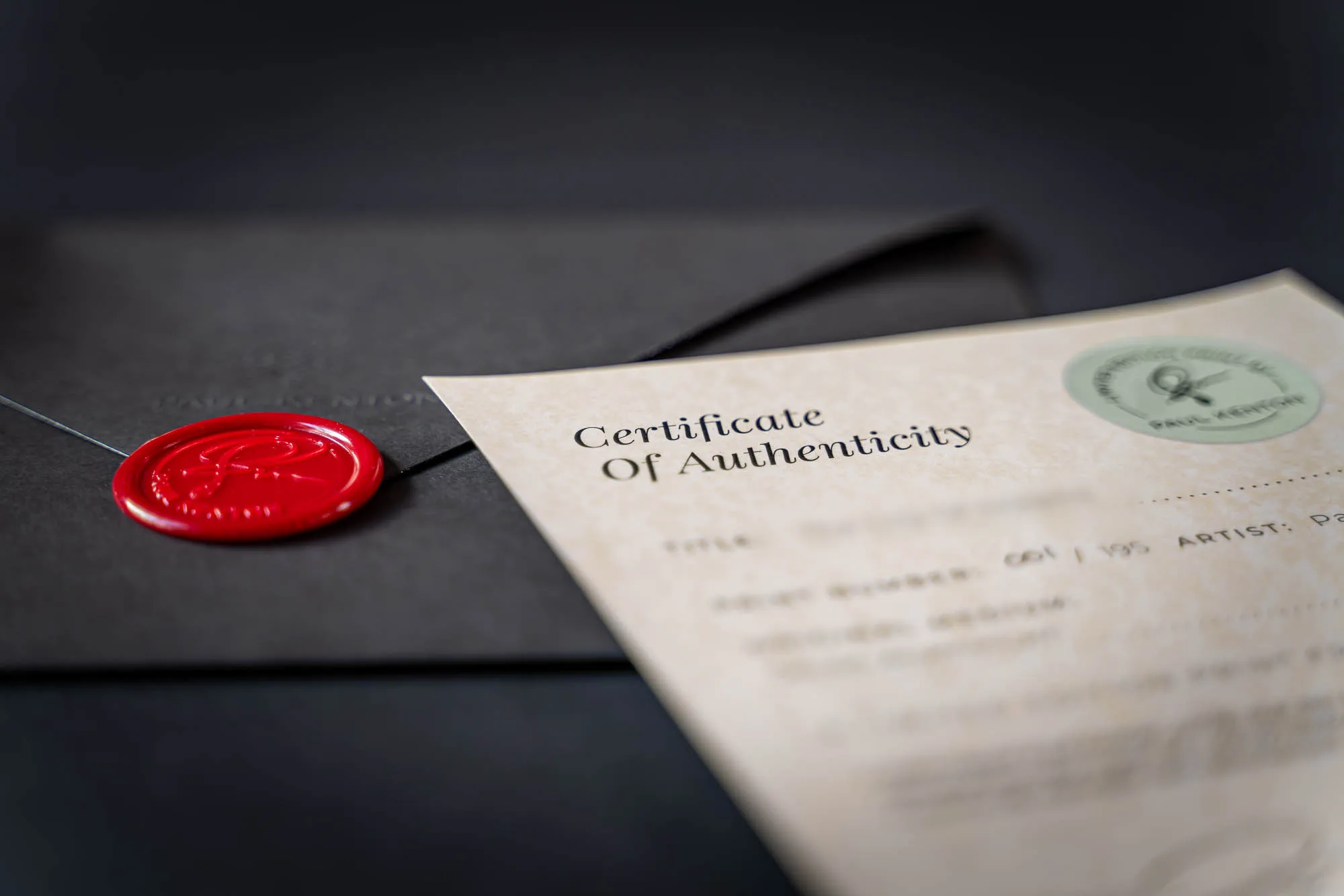 A Paul Kenton Certificate of Authenticity beside a black envelope sealed with red wax